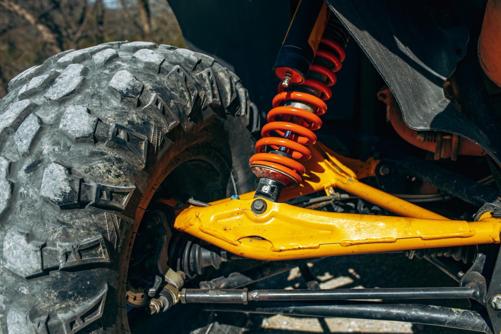 Suspension and shock absorber repair on a car lift at Tampa Bay Quick Lube in Tampa, FL