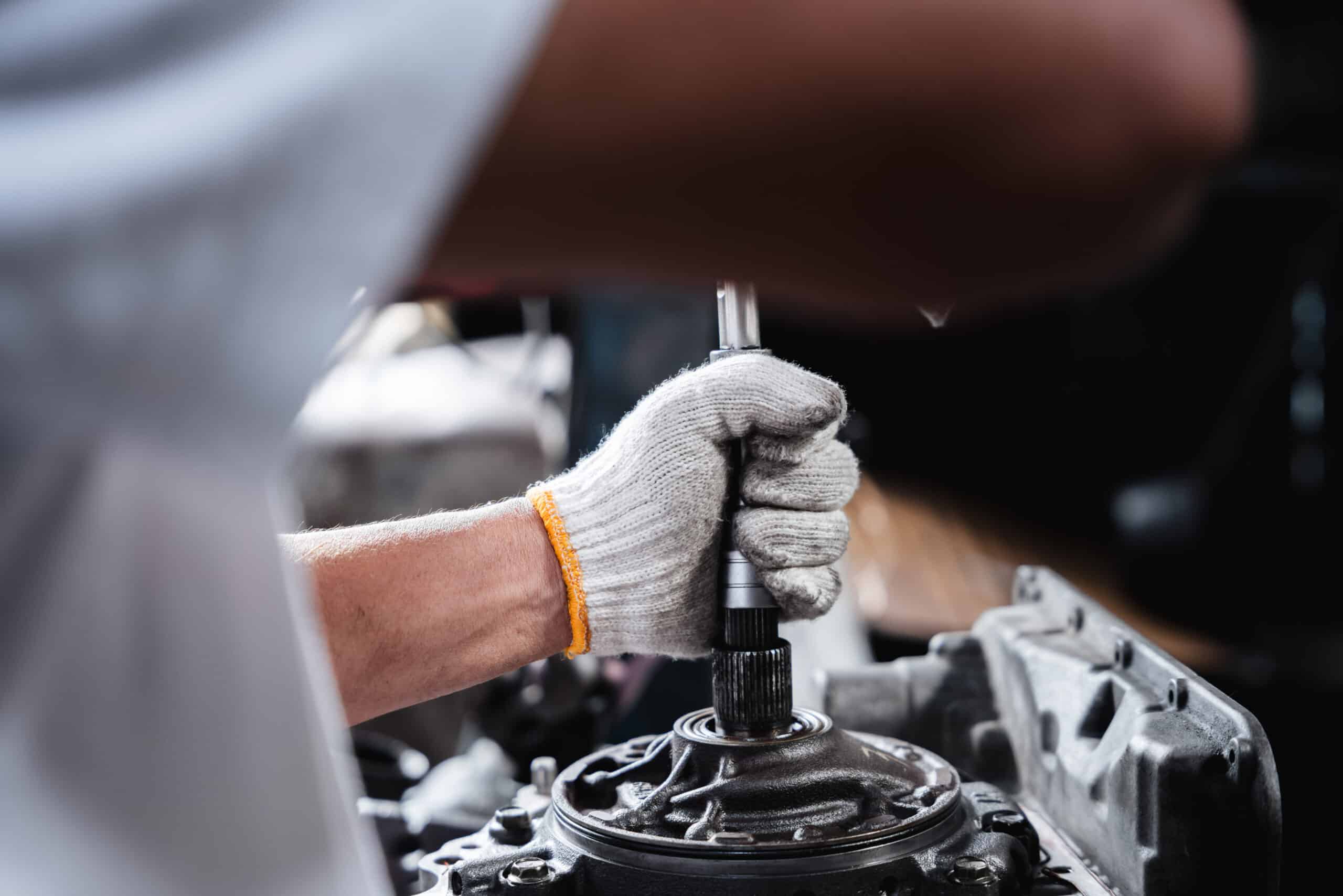 Close up mechanic repairing transmission